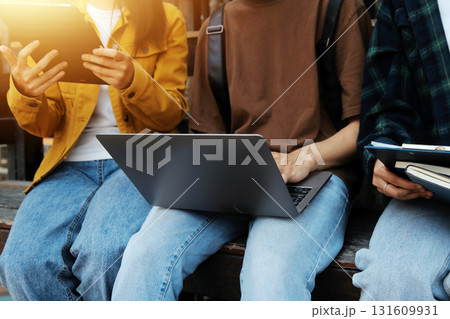 Happy students walking together on university campus, chatting and laughing outdoors after classes Happy students walking together on university campus, chatting and laughing outdoors after classes 131609931