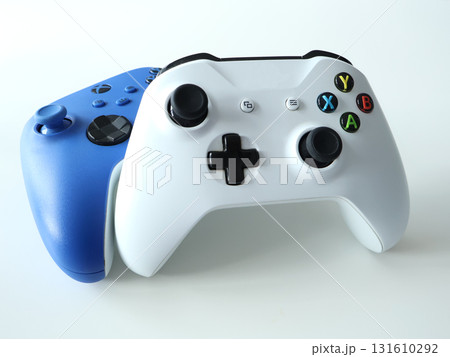White And Blue Wireless Game Controllers Overlapping For Modern Gaming Enthusiasts White And Blue Wireless Game Controllers Overlapping For Modern Gaming Enthusiasts 131610292
