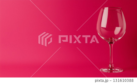 Elegant wine glass on vibrant pink background with empty space for contemporary design 131610388