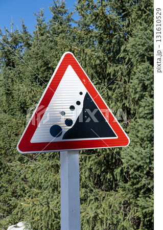 the sign warns of an avalanche of rocks the sign warns of an avalanche of rocks 131610529