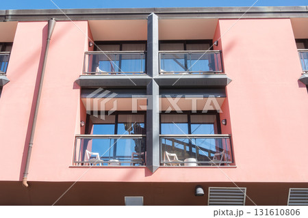 Modern apartment building with balconies. Concept of urban architecture, housing, real estate, residential lifestyle Modern apartment building with balconies. Concept of urban architecture, housing, real estate, residential lifestyle 131610806