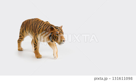 plastic toy tiger figure on a white background plastic toy tiger figure on a white background 131611098