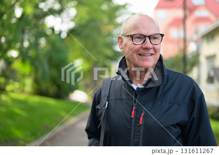 Portrait of a smiling senior man in sportswear standing outdoors Portrait of a smiling senior man in sportswear standing outdoors 131611267