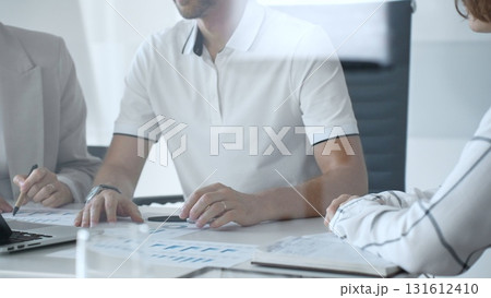 Business people team collaborating in a modern office, analyzing financial data and discussing growth strategies during an engaging and productive meeting focused on achieving success, close up Business people team collaborating in a modern office, analyzing financial data and discussing growth strategies during an engaging and productive meeting focused on achieving success, close up 131612410