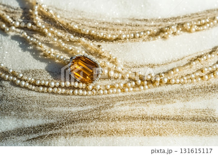 Elegant gold and pearl jewelry displayed on sandy background for luxury lifestyle photography 131615117
