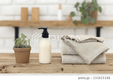 Elegant Bathroom Setup with Lotion Bottle, Towels, Succulent Plant and Minimalist Decor Elegant Bathroom Setup with Lotion Bottle, Towels, Succulent Plant and Minimalist Decor 131615188