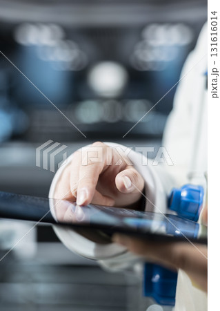 Close up of astronaut checking orbital navigation data on tablet to ensure safe operation during long distance space travel. Orbital station crew member runs telemetry software during cosmic journey Close up of astronaut checking orbital navigation data on tablet to ensure safe operation during long distance space travel. Orbital station crew member runs telemetry software during cosmic journey 131616014