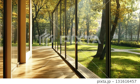 Sunlight Glimmers on Modern Building Facade with Large Windows and Natural Stone Textures 131616457