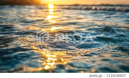 Serene Ocean Waves at Sunset with Glowing Reflections and Calm Water Surface 131616607