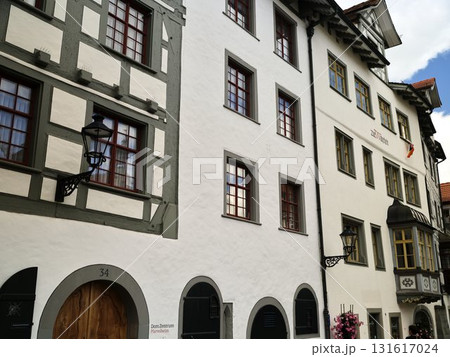 Historic buildings along a charming street in a quaint village showcasing traditional architecture and vibrant windows 131617024