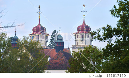 Colorful church towers stand out against a clear sky in a serene landscape 131617130