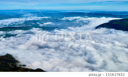 Breathtaking view over a sea of clouds from a high mountain landscape in the morning light showcasing the beauty of nature Breathtaking view over a sea of clouds from a high mountain landscape in the morning light showcasing the beauty of nature 131617652