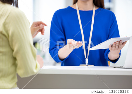 カウンセリング　窓口で説明している女性の手元 131620338