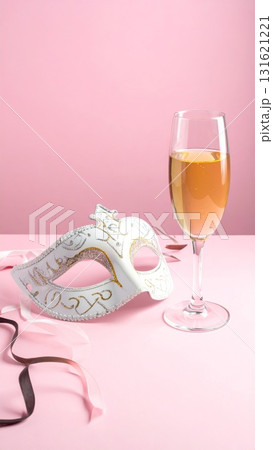 Two glasses of champagne and gold confetti for a masquerade celebration 131621221