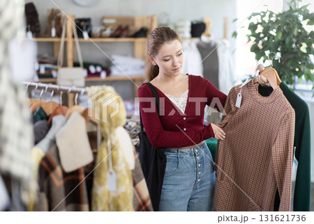 Young woman choosing a dress 131621736