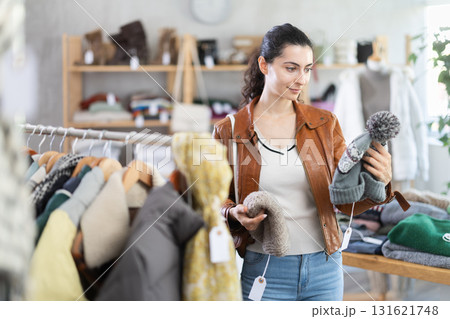 Armenian woman near showcase examine goods, hat. 131621748