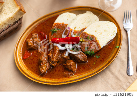 Meat goulash with onions, red pepper. Served with bread and gravy. Slovak cuisine 131621909