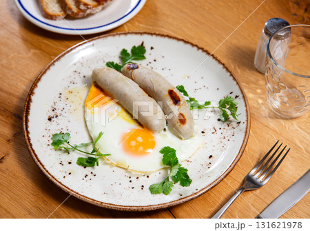 Delicious hearty breakfast with scrambled eggs and sausage closeup 131621978
