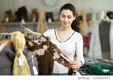 Armenian woman choosing a knitted cardigan 131622071