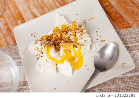 Mato cheese served with honey and sesame seeds 131622199
