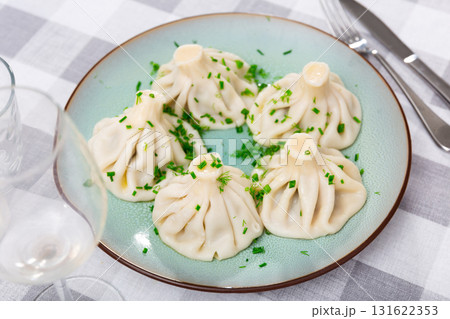 Georgian khinkali dumplings served with herbs Georgian khinkali dumplings served with herbs 131622353