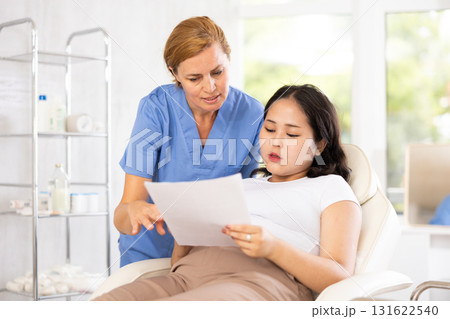 Middle-aged doctor consulting with documents Middle-aged doctor consulting with documents 131622540