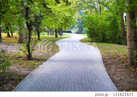 Winding Brick Path Through Lush Park With Trees And Dappled Light Winding Brick Path Through Lush Park With Trees And Dappled Light 131622631