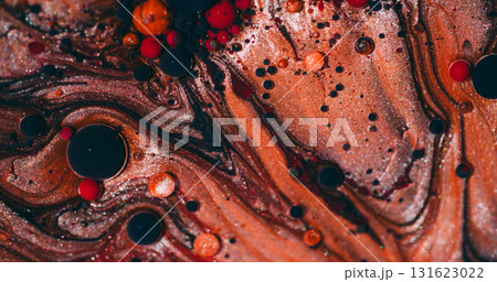 Oil marble. Ink blend. Defocused orange red purple color splatter glitter round water bubbles dark black emulsion spill on abstract background. 131623022