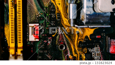 Ink flow. Digital hardware. Blur yellow green red colorful glitter water dark black electronic microchip on abstract art background. 131623024