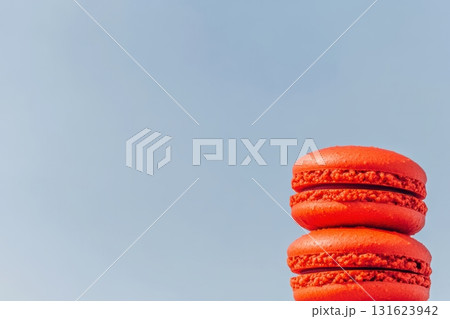 Red macarons stacked against a clear blue sky during a sunny day Red macarons stacked against a clear blue sky during a sunny day 131623942