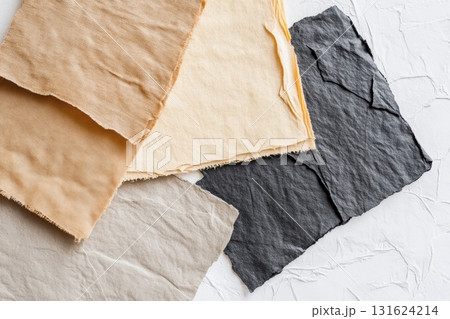 Textiles of various colors and textures arranged on a neutral background 131624214