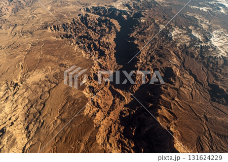 Stunning aerial view of a vast canyon landscape under bright sunlight Stunning aerial view of a vast canyon landscape under bright sunlight 131624229