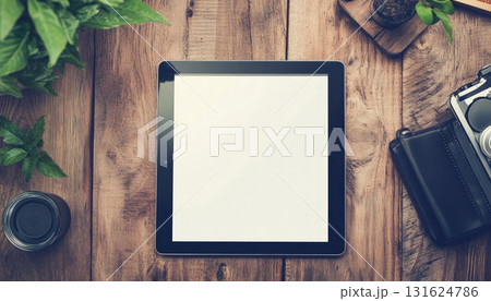 Overhead View Of Tablet With Blank Screen On Wooden Desk With Plants Sunglasses Camera And Other Objects 131624786