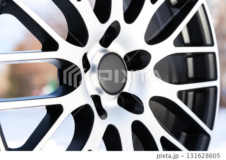 Alloy wheels are prominently displayed outdoors, highlighting their dynamic design and durable construction. The distinctive pattern and elegant finish emphasize sport tuning potential for cars. 131628605