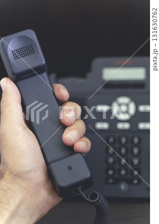 Hand Holding Telephone Handset. Communication and Connection Hand Holding Telephone Handset. Communication and Connection 131630762