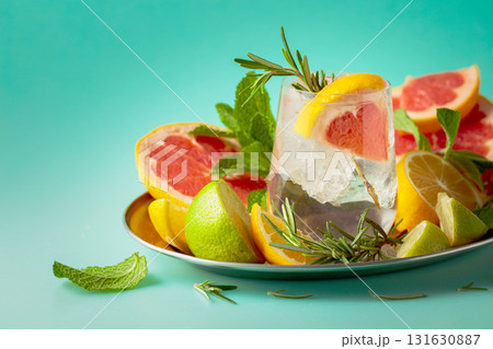 Refreshing summer drink with ice, citrus, rosemary and mint. Refreshing summer drink with ice, citrus, rosemary and mint. 131630887