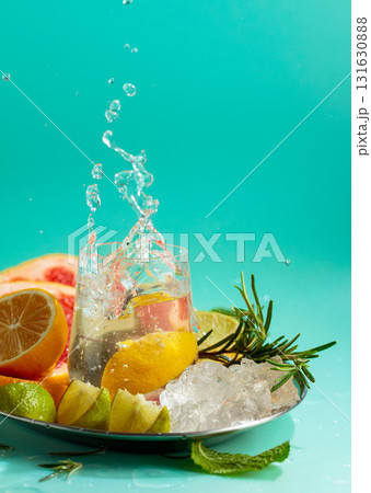 A refreshing summer drink with ice, citrus, rosemary and mint. 131630888
