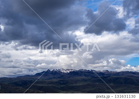 Snow-capped mountain under dark storm clouds in the Peruvian highlands Snow-capped mountain under dark storm clouds in the Peruvian highlands 131631130
