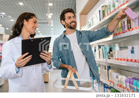 Pharmacist woman explaining medical products to male customer 131632171