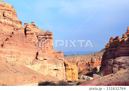 Picturesque scenery of Charyn Canyon in the sunset light, northern region of Tien Shan Mountains. Famous landmark Natural monument Valley of Castles, National Nature Park, Almaty region, Kazakhstan Picturesque scenery of Charyn Canyon in the sunset light, northern region of Tien Shan Mountains. Famous landmark Natural monument Valley of Castles, National Nature Park, Almaty region, Kazakhstan 131632764