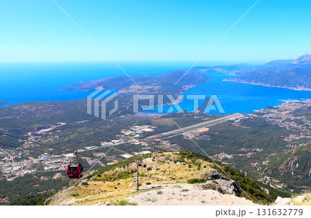 A cable car in Montenegro. Aerial view of picturesque cableway and Bay of Kotor. Top view on Tivat, mountains and Adriatic Sea, Montenegro. Bird's-eye view of Gulf of Kotor, view from Mount Lovcen A cable car in Montenegro. Aerial view of picturesque cableway and Bay of Kotor. Top view on Tivat, mountains and Adriatic Sea, Montenegro. Bird's-eye view of Gulf of Kotor, view from Mount Lovcen 131632779