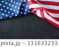 United States flag on black backdrop with copy space, great for banners, posters, and digital designs for patriotic events such as Independence Day, Veterans Day, Labor Day,Memorial Day. 131633233