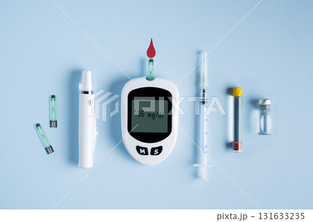 Set of diabetic tools glucometer, insulin bottle, syringe, and lancet for blood testing, medical equipment. Diabetes testing concept, world diabetes day background. 131633235