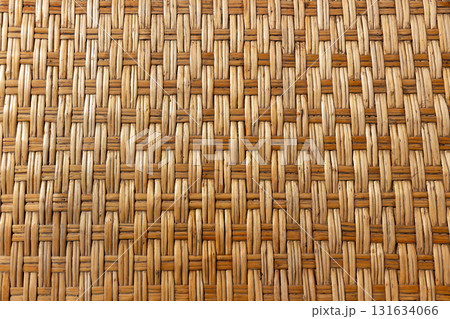 Natural rattan weave texture showing intricate handwoven pattern in warm brown and beige tones. Rustic, tropical look, ideal for backgrounds, furniture design, and eco-style decoration concepts Natural rattan weave texture showing intricate handwoven pattern in warm brown and beige tones. Rustic, tropical look, ideal for backgrounds, furniture design, and eco-style decoration concepts 131634066