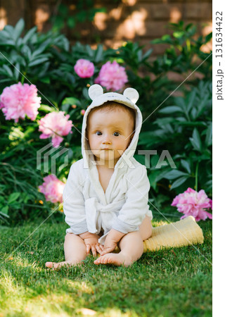Baby Sitting On Grass With Flowers Baby Sitting On Grass With Flowers 131634422