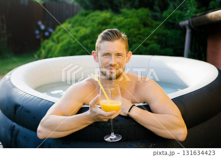 Smiling Man In Pool Holding Juice Smiling Man In Pool Holding Juice 131634423