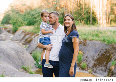 Loving Parents And Child Posing For Summer Outdoor Memories 131634424