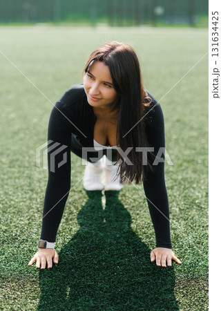 Young Woman In Fitness Pose Outdoors 131634425