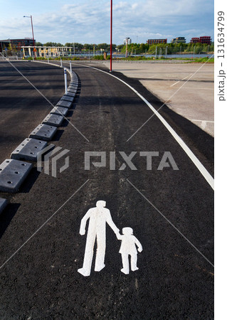Sidewalk sign depicting walking adult holding a childs hand on the streets of Gothenburg, Sweden, sunny summer day, 15 minute city concept Sidewalk sign depicting walking adult holding a childs hand on the streets of Gothenburg, Sweden, sunny summer day, 15 minute city concept 131634799