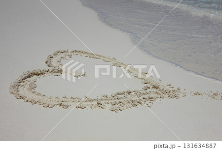 Heart drawn in the sand. Beach background. Top view 131634887